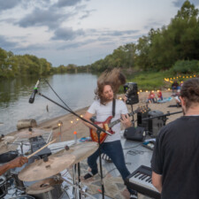 A Rising Tide Band performance on a beach